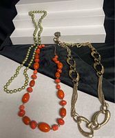 overview of three necklaces arranged together