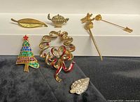 Group shot of all six brooches and pins on display