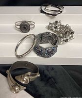 All six rings displayed on stepped white stand