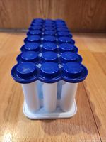 Front angle showing full mold with blue lid and white tubes