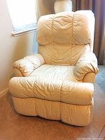 Full front view of beige leather recliner upright