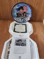 Front view of plate on stand showing full artwork and COA