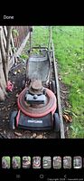 Full view of Craftsman red push mower with rear bag on grass