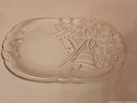 Full view of oval glass platter showing scalloped edge and holiday design