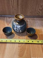 Tokkuri carafe and two ochoko cups with measuring tape
