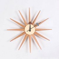 Front view of entire sunburst clock showing 12 wooden rays and dial