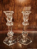 Both clear faceted crystal candlesticks front view