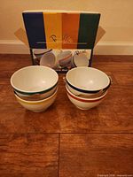 All four bowls stacked in pairs with retail box