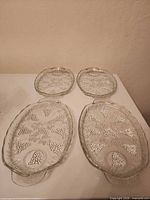 Full set of four glass platters/dishes laid out