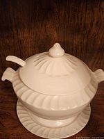 tureen with lid and ladle on underplate
