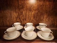 Set of six cups each on its saucer displayed together
