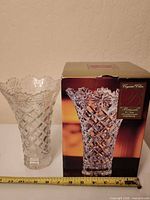 Vase beside original box with measuring tape showing height