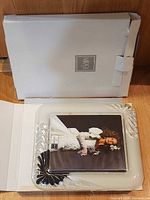 Frame in open box with placeholder photo and outer carton visible