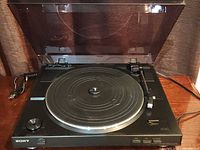 Overall view of Sony turntable with dust cover open