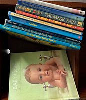 Stack of nine children’s books showing titles and cover of Baby Love
