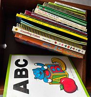 Stack of assorted children’s books showing spines for title confirmation