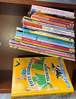 Stack of assorted children’s books showing spines and large ‘Fifty Stories for 7 Year Olds’