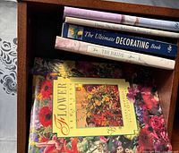 Stack of five hardcover books inside drawer