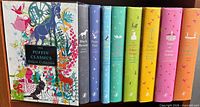 Front view of slipcase and book spines showing all eight titles