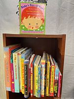 Shelf of numerous baby board books with Baby’s Box of Fun! displayed