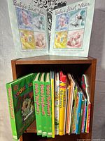 Shelf with baby memory calendars and numerous children's board books