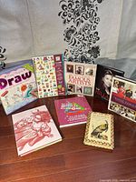 Group shot of all eight books spread on floor