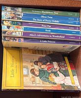 Stack of eight paperback classics showing titles on spines