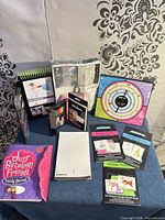 All items laid out on table showing portfolio, sealed tote kit, design guides, pencils, journal and blank pad
