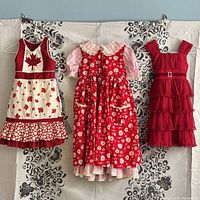 Front view of three dresses on hanger