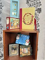 Overall view of albums, frames and tin on shelving