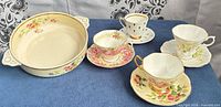 Group showing all four teacup/saucer sets and serving bowl
