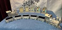 Full lot showing two locomotive banks, six trinket boxes, seven freestanding frames