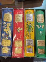 Spines of all four colour-coded fairy books in slipcases