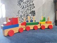 Side view of one assembled wooden block train with colourful blocks