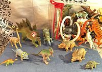 Group shot of all dinosaur figures and clear zip pouch of parts