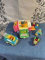 Group shot of camper van, car, motorbike, figures and accessories