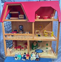Full view of dollhouse with furniture and dolls displayed