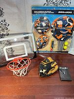 Group shot: mini hoop, sealed Sea-Doo paddle set, Wilson glove, Leafs capsule