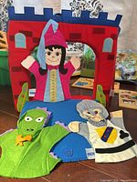 Fabric puppet theater with three hand puppets displayed