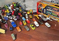 Wide view showing pile of loose die-cast vehicles and boxed Rolling Thunder set