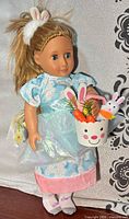 Front view of doll holding Easter basket