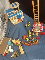 Overall lot showing police station, grocery belt, ladder, fire tower, vehicles and figures