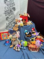 Group shot showing all plush animals, Pixy Cubes tin, Dreams book and decorative boxes