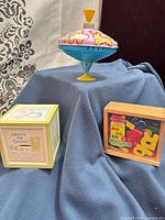 Group view of spinning top and two wooden banks