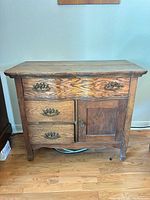 Front view of entire oak sideboard showing drawers, door, hardware and overall finish