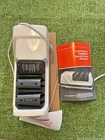 Top view of sharpener and manual showing overall condition and accessories