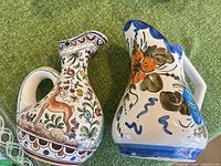 Two pitchers shown; lot item is the left deer-motif pitcher