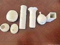 All seven white porcelain pieces arranged on table