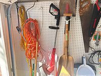 Overall view showing extension cords, saw frame, shovel and assorted tools