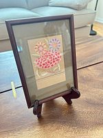 Front view of mahogany wood 5x7 picture frame on tabletop easel stand